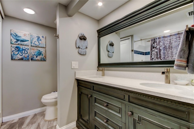 400 Island Way Unit 1709, Clearwater Beach, FL 33767 - bathroom featuring double vanity, toilet, baseboards, and curtained shower