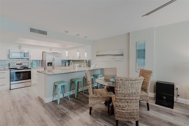 400 Island Way Unit 1709, Clearwater Beach, FL 33767 - dining area featuring light wood finished floors