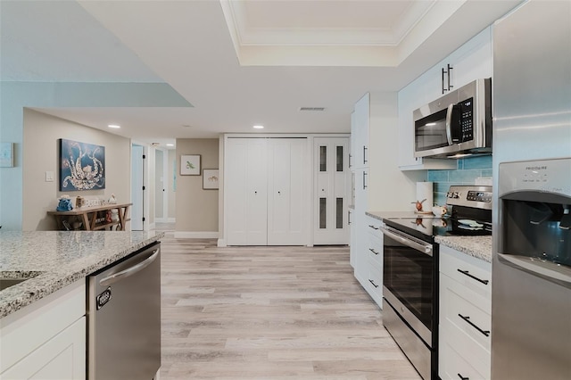 400 Island Way Unit 1709, Clearwater Beach, FL 33767 - kitchen with appliances with stainless steel finishes, a raised ceiling, light wood finished floors, white cabinets, and recessed lighting