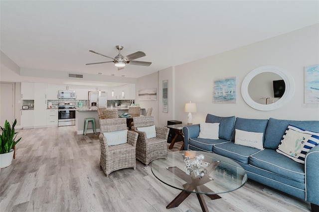 400 Island Way Unit 1709, Clearwater Beach, FL 33767 - living area featuring light wood-type flooring and ceiling fan