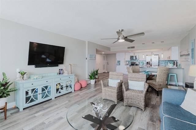 400 Island Way Unit 1709, Clearwater Beach, FL 33767 - living room featuring a ceiling fan and light wood finished floors