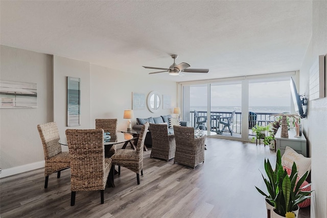 400 Island Way Unit 1709, Clearwater Beach, FL 33767 - dining area featuring wood finished floors, healthy amount of natural light, ceiling fan, a textured ceiling, and expansive windows