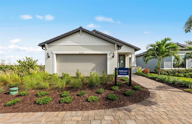 ranch-style house featuring stucco siding, an attached garage, and driveway
