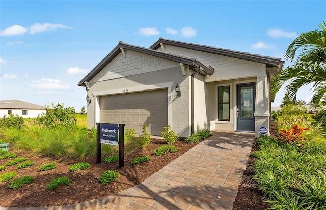 view of front of house with stucco siding and a garage