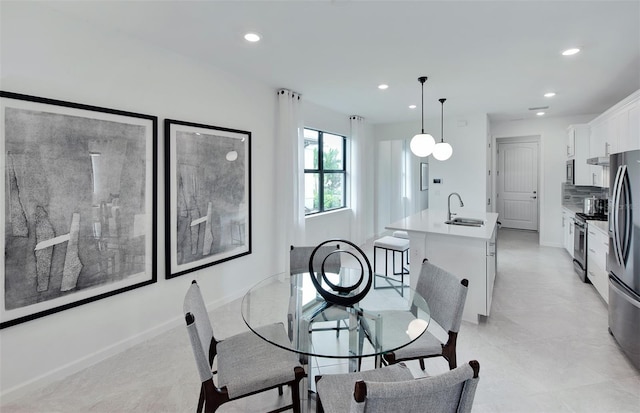 dining space featuring recessed lighting and baseboards