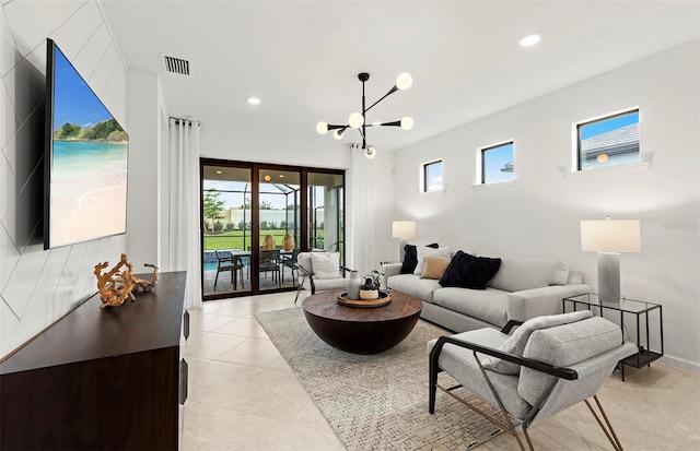 living room featuring a chandelier, recessed lighting, and light tile patterned floors