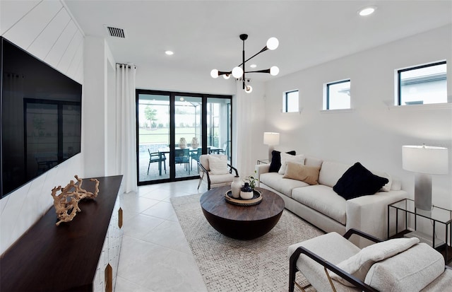living room with recessed lighting, light tile patterned floors, and a chandelier