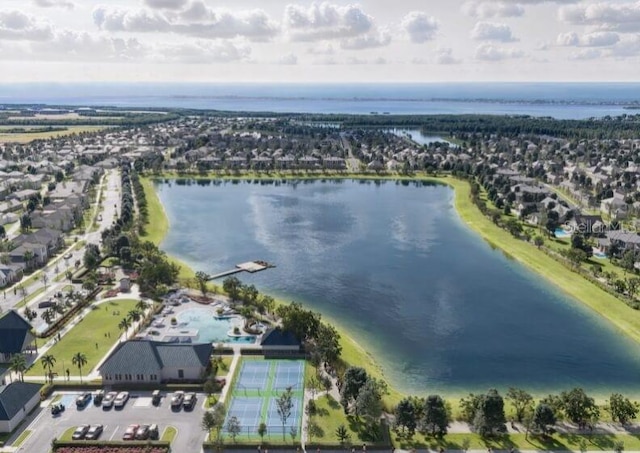 aerial view of property and surrounding area with a nearby body of water