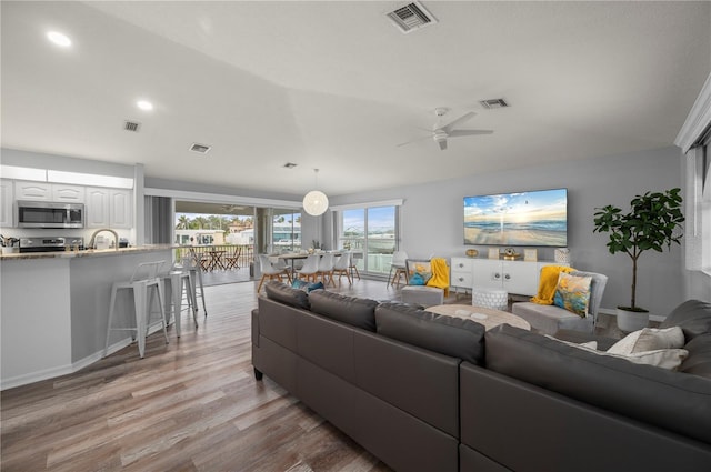 5193 Boyle Ter, Port Charlotte, FL 33981 - living room featuring light wood finished floors, a ceiling fan, and recessed lighting