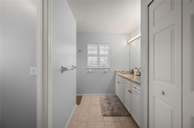 5193 Boyle Ter, Port Charlotte, FL 33981 - bathroom featuring tile patterned flooring, vanity, a textured ceiling, and baseboards