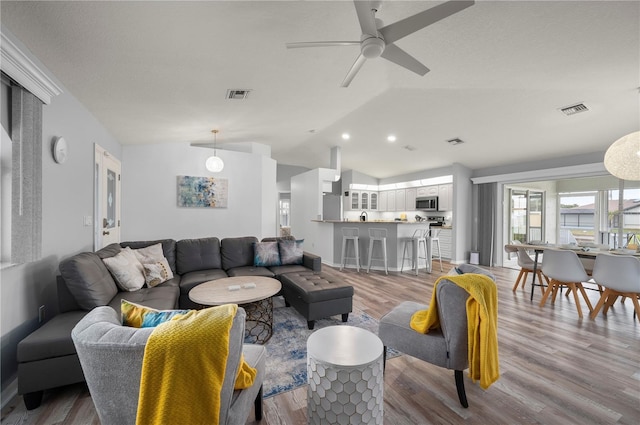 5193 Boyle Ter, Port Charlotte, FL 33981 - living room with vaulted ceiling, wood finished floors, plenty of natural light, a ceiling fan, and recessed lighting