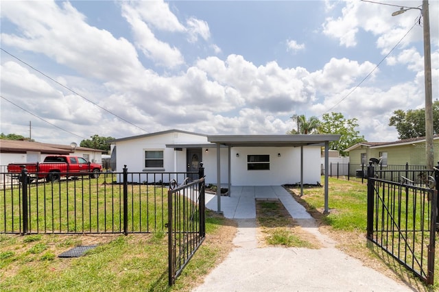 5210 S 80th St, Tampa, FL 33619 - view of front of home with driveway, an attached carport, and stucco siding