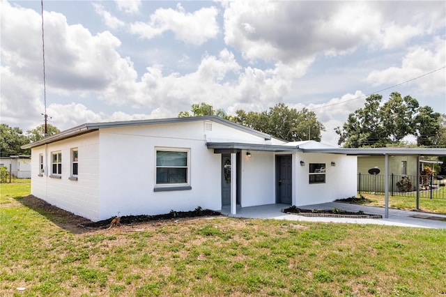 5210 S 80th St, Tampa, FL 33619 - view of front facade featuring stucco siding and a carport