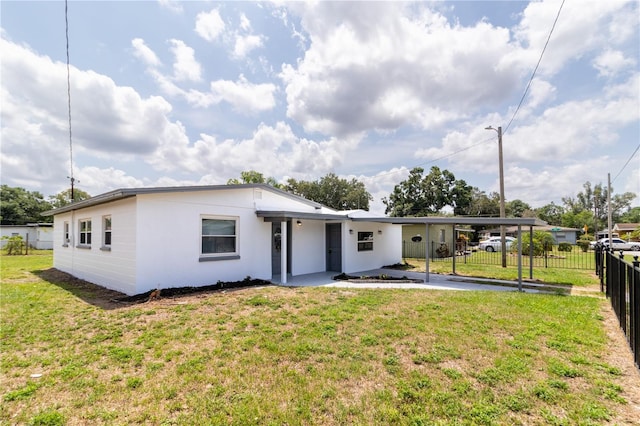 5210 S 80th St, Tampa, FL 33619 - rear view of property featuring an attached carport and stucco siding