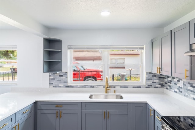 5210 S 80th St, Tampa, FL 33619 - kitchen featuring a sink, gray cabinetry, light countertops, a textured ceiling, and recessed lighting