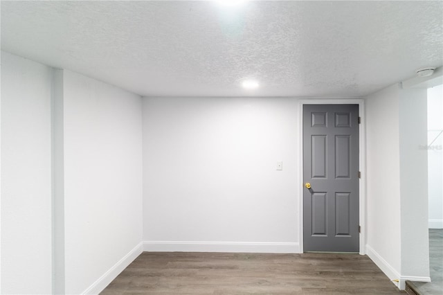 5210 S 80th St, Tampa, FL 33619 - unfurnished room featuring a textured ceiling, baseboards, wood finished floors, and a smoke detector