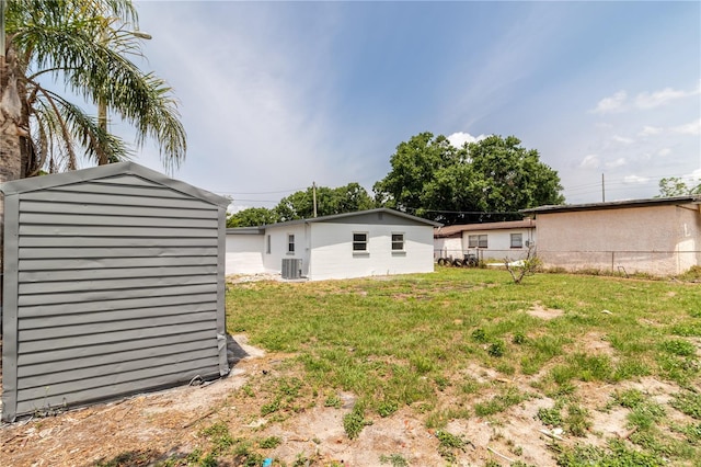 5210 S 80th St, Tampa, FL 33619 - view of yard featuring central AC, an outdoor structure, and a storage unit