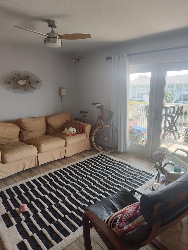 living room featuring wood finished floors and a ceiling fan