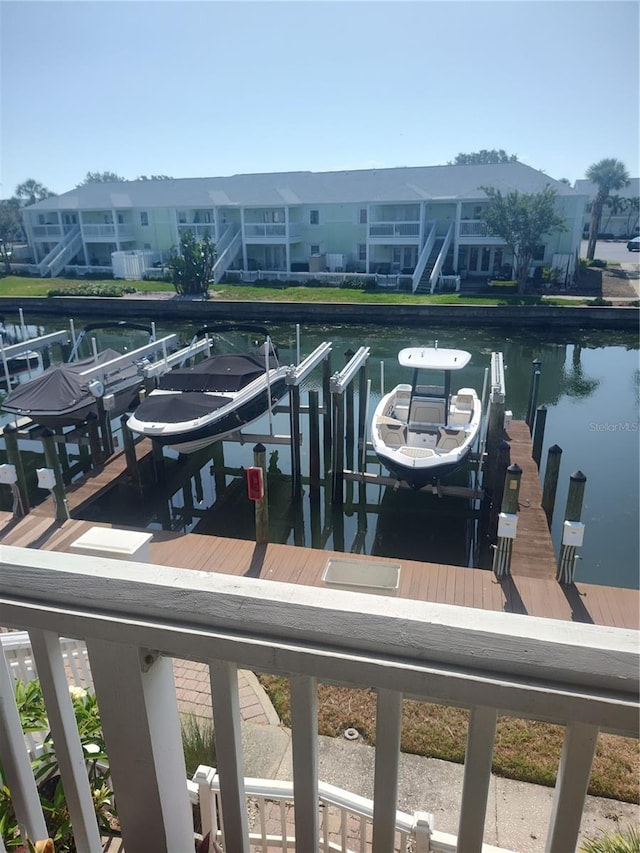 dock area with boat lift and a water view
