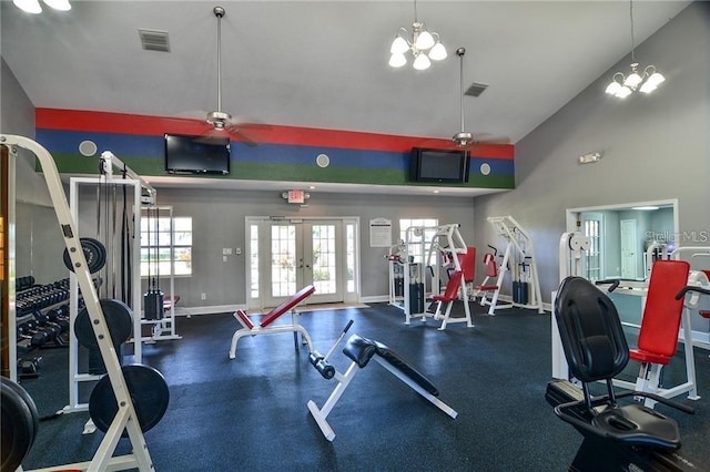 gym with baseboards, french doors, visible vents, and vaulted ceiling