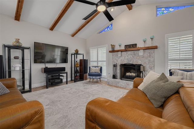 315 Ridge Rd, Palm Harbor, FL 34683 - living area with high vaulted ceiling, beam ceiling, a ceiling fan, a fireplace, and baseboards