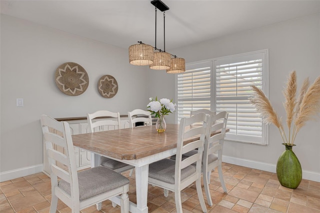 315 Ridge Rd, Palm Harbor, FL 34683 - dining space featuring stone tile flooring and baseboards