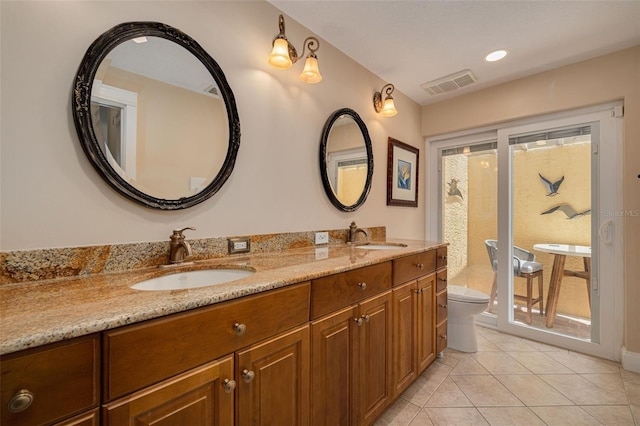 315 Ridge Rd, Palm Harbor, FL 34683 - full bathroom with toilet, tile patterned floors, and double vanity