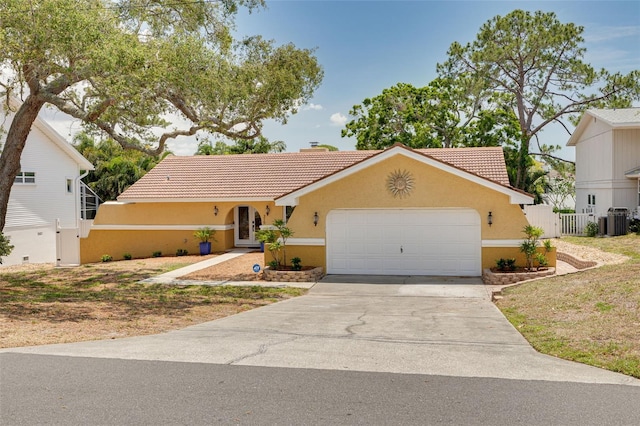 315 Ridge Rd, Palm Harbor, FL 34683 - view of front of house with stucco siding, a tiled roof, a garage, and concrete driveway