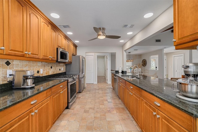 315 Ridge Rd, Palm Harbor, FL 34683 - kitchen with a sink, stainless steel appliances, brown cabinetry, ceiling fan, and tasteful backsplash
