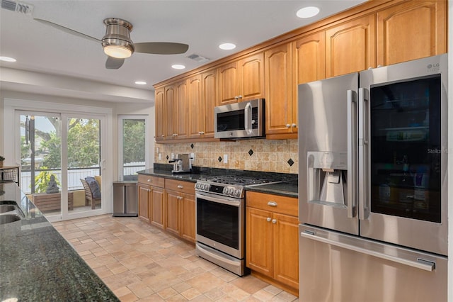 315 Ridge Rd, Palm Harbor, FL 34683 - kitchen featuring appliances with stainless steel finishes, ceiling fan, backsplash, dark stone countertops, and recessed lighting