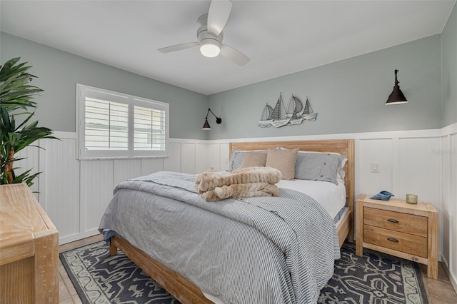 315 Ridge Rd, Palm Harbor, FL 34683 - bedroom featuring wainscoting, a decorative wall, and ceiling fan