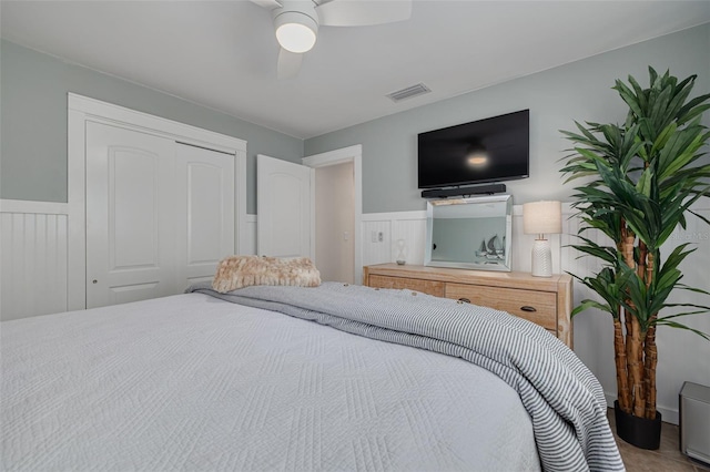 315 Ridge Rd, Palm Harbor, FL 34683 - bedroom with a wainscoted wall, a closet, and a ceiling fan