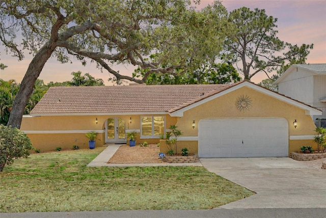 315 Ridge Rd, Palm Harbor, FL 34683 - ranch-style house with an attached garage, stucco siding, driveway, french doors, and a lawn