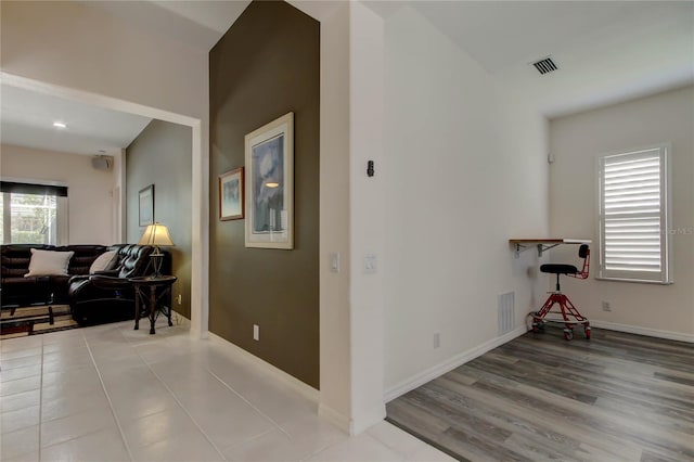 hall with wood finished floors, baseboards, and recessed lighting