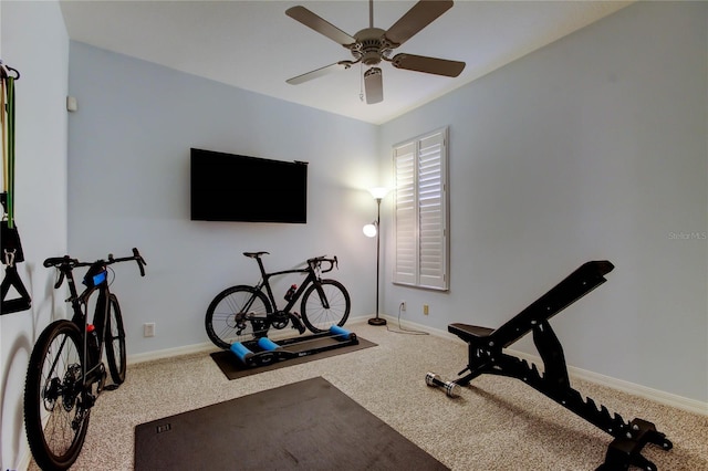 exercise room featuring ceiling fan, carpet flooring, and baseboards