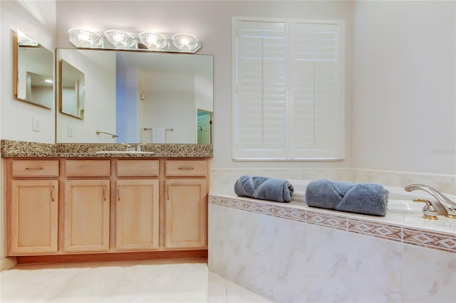 full bathroom with vanity and a bath