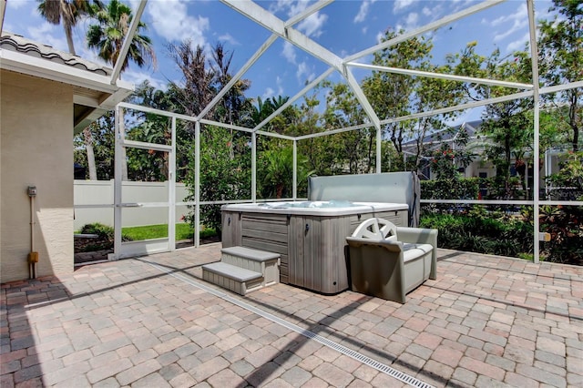 view of patio with a hot tub and a lanai