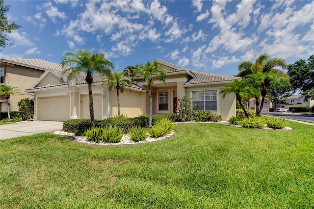 view of front of property featuring stucco siding, concrete driveway, an attached garage, a tiled roof, and a front yard