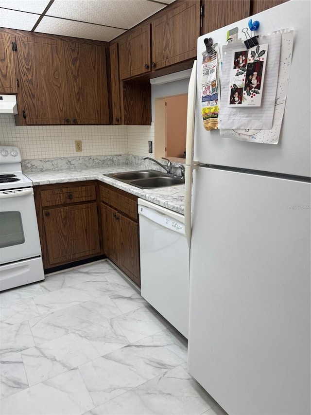 kitchen featuring white appliances, extractor fan, a sink, light marble finish flooring, and light countertops