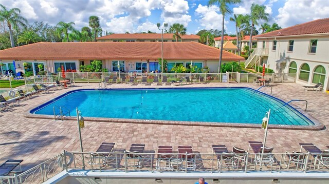 pool featuring fence and a patio