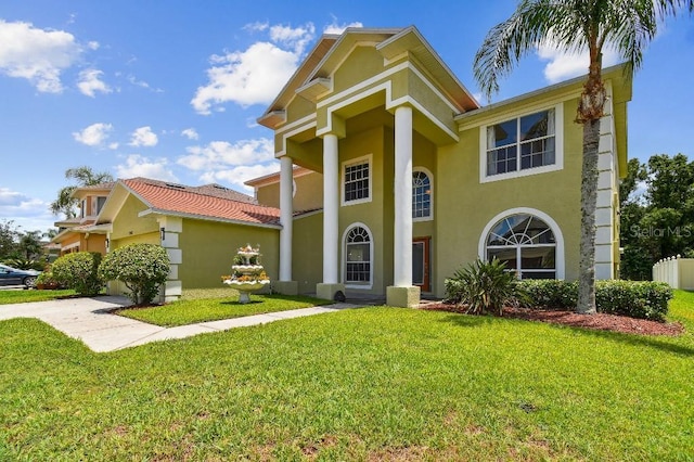 27012 Sea Breeze Way, Wesley Chapel, FL 33544 - greek revival house with stucco siding and a front yard