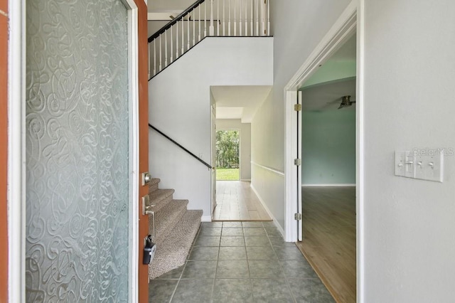 27012 Sea Breeze Way, Wesley Chapel, FL 33544 - entrance foyer with stairway, tile patterned flooring, and baseboards