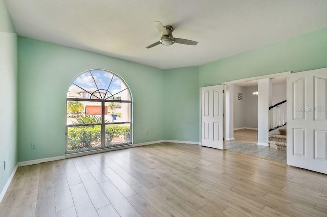 27012 Sea Breeze Way, Wesley Chapel, FL 33544 - unfurnished bedroom with wood finished floors, baseboards, and a ceiling fan