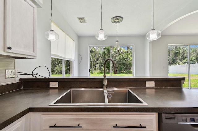 27012 Sea Breeze Way, Wesley Chapel, FL 33544 - kitchen with a sink, dark countertops, dishwasher, and plenty of natural light