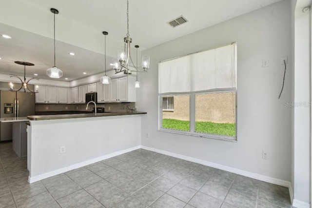 27012 Sea Breeze Way, Wesley Chapel, FL 33544 - kitchen featuring stainless steel fridge, a chandelier, decorative light fixtures, recessed lighting, and baseboards