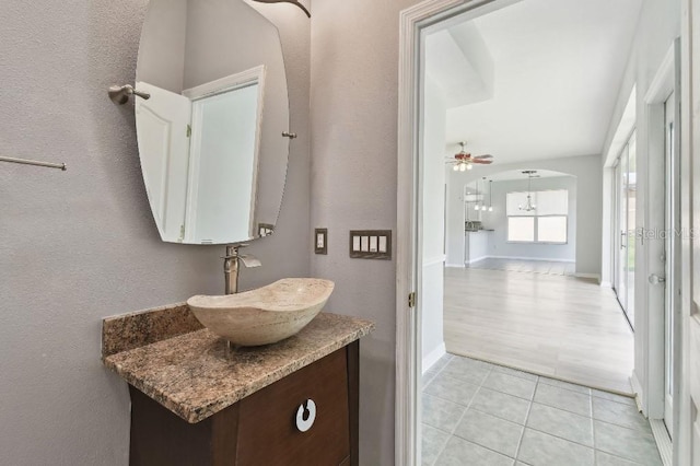 27012 Sea Breeze Way, Wesley Chapel, FL 33544 - bathroom with vanity, tile patterned floors, ceiling fan, baseboards, and a textured wall