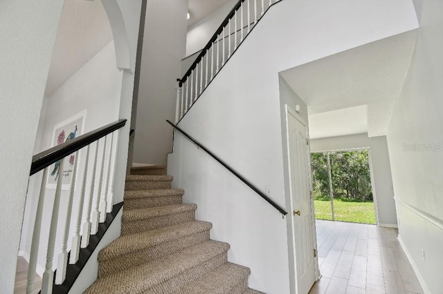 27012 Sea Breeze Way, Wesley Chapel, FL 33544 - stairway with arched walkways and baseboards