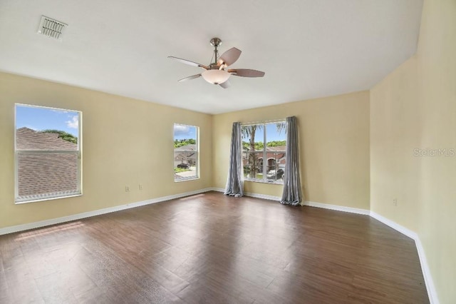 27012 Sea Breeze Way, Wesley Chapel, FL 33544 - spare room featuring ceiling fan, dark wood-style floors, and baseboards