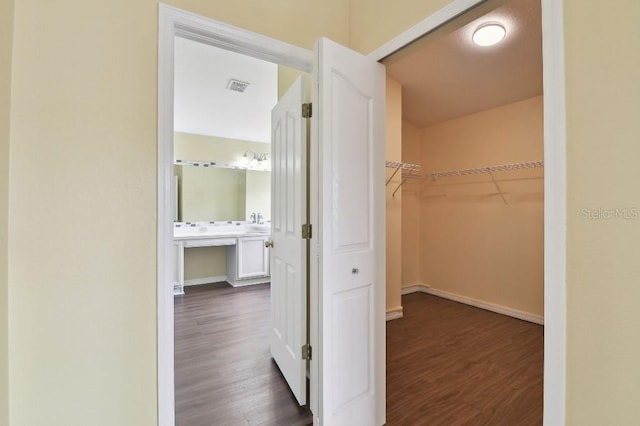 27012 Sea Breeze Way, Wesley Chapel, FL 33544 - walk in closet with dark wood-style flooring