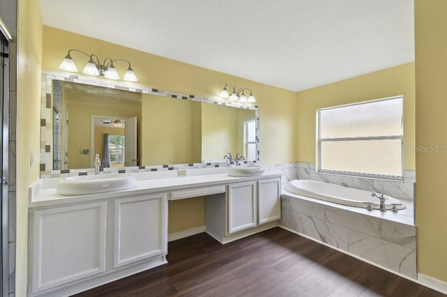 27012 Sea Breeze Way, Wesley Chapel, FL 33544 - bathroom featuring double vanity, wood finished floors, and a garden tub